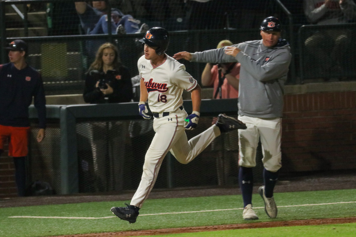 Ike Irish rounds third after hitting a home run for Auburn baseball against Alabama.